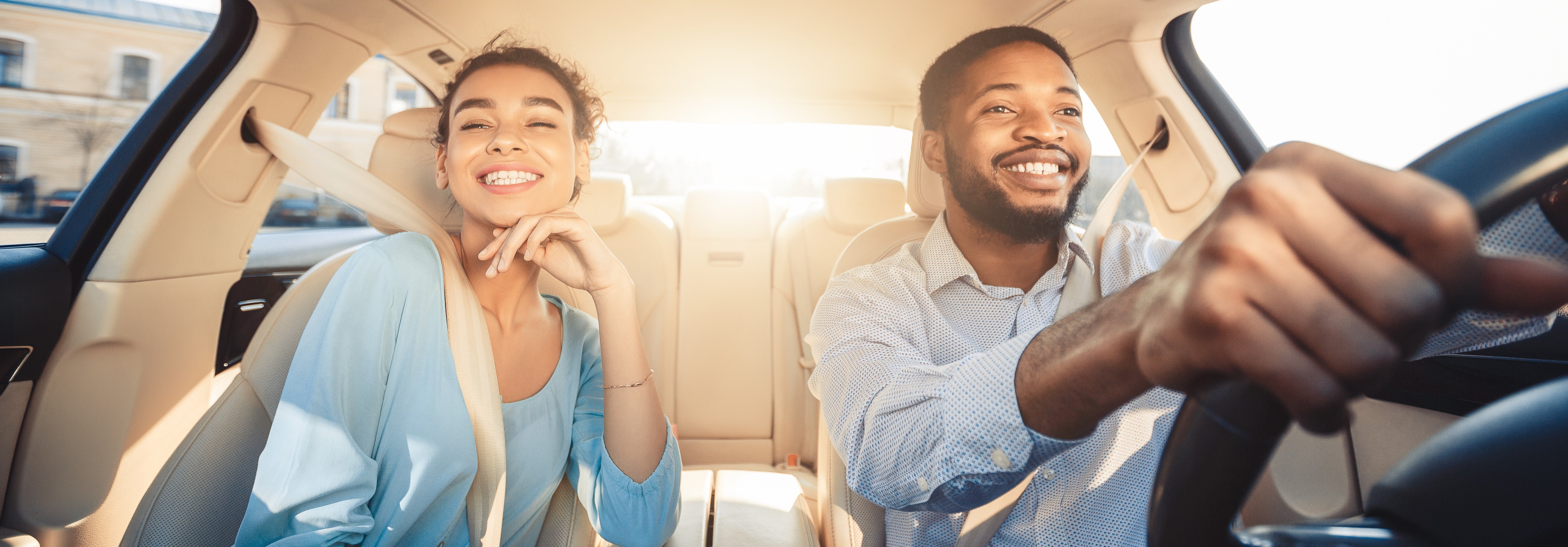 Couple driving in their new car