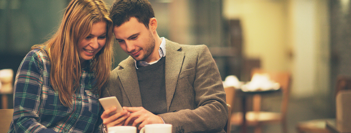 two people looking at a cell phone
